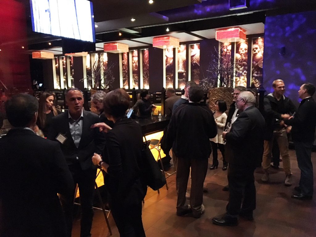 CIET Connect attendees speaking and shaking hands in a restaurant