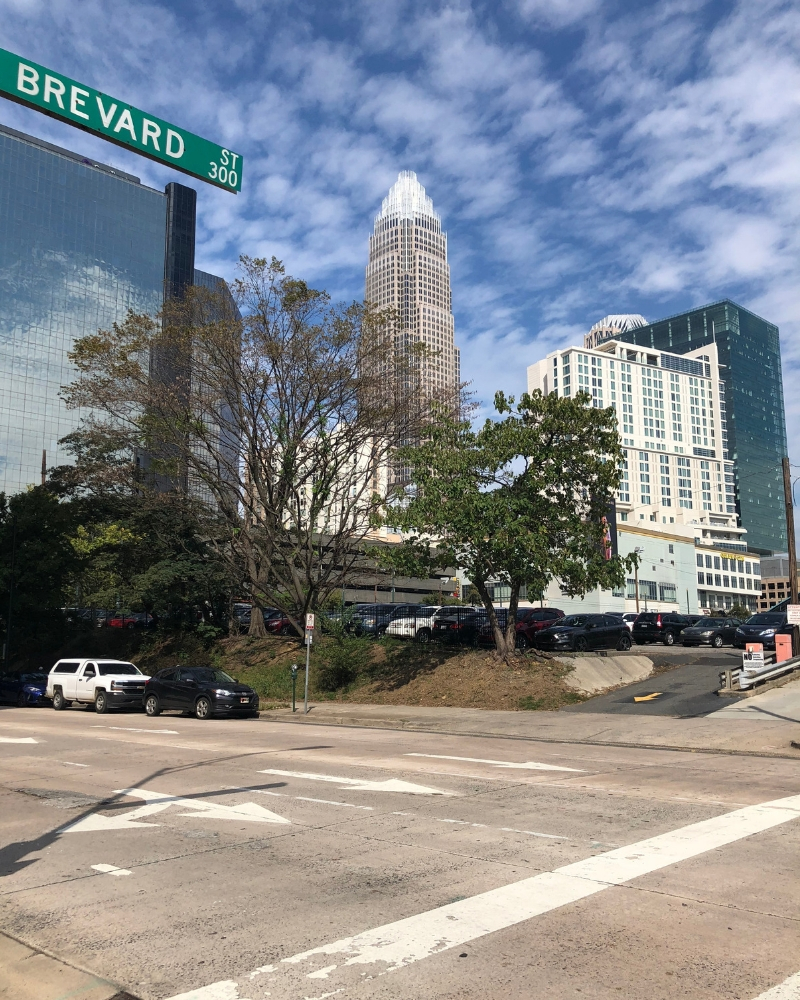 Tall buildings and sky in Charlotte, North Carolina in front of Brevard St sign