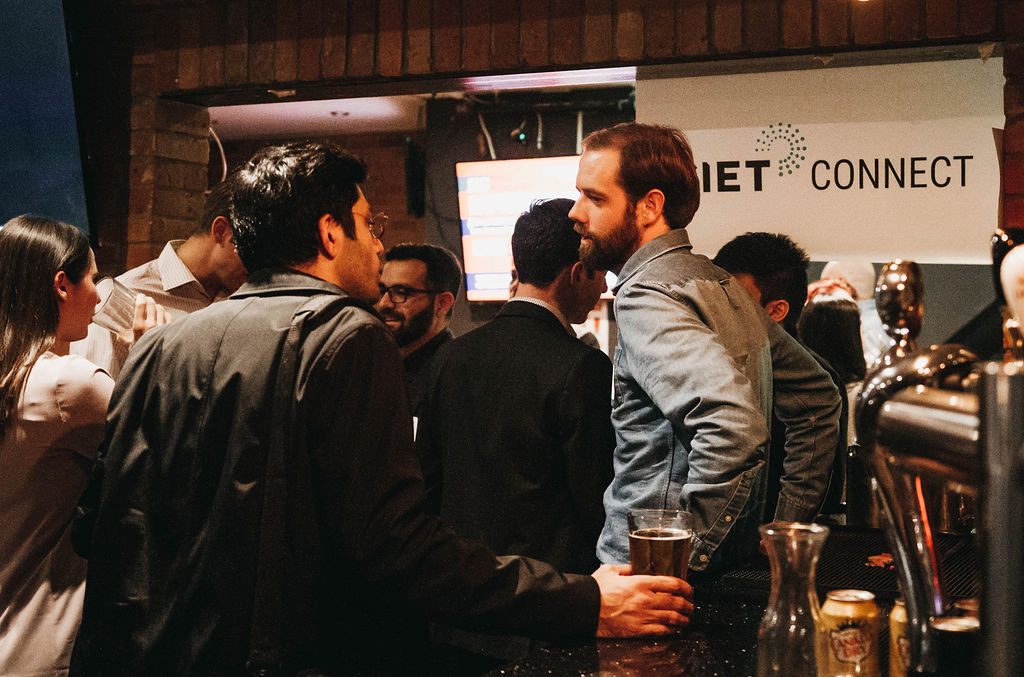 people networking in front of a CIET Connect sign
